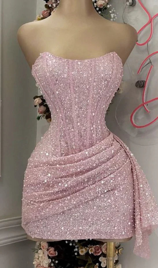 Back view of a model wearing the pink sequin strapless homecoming dress.