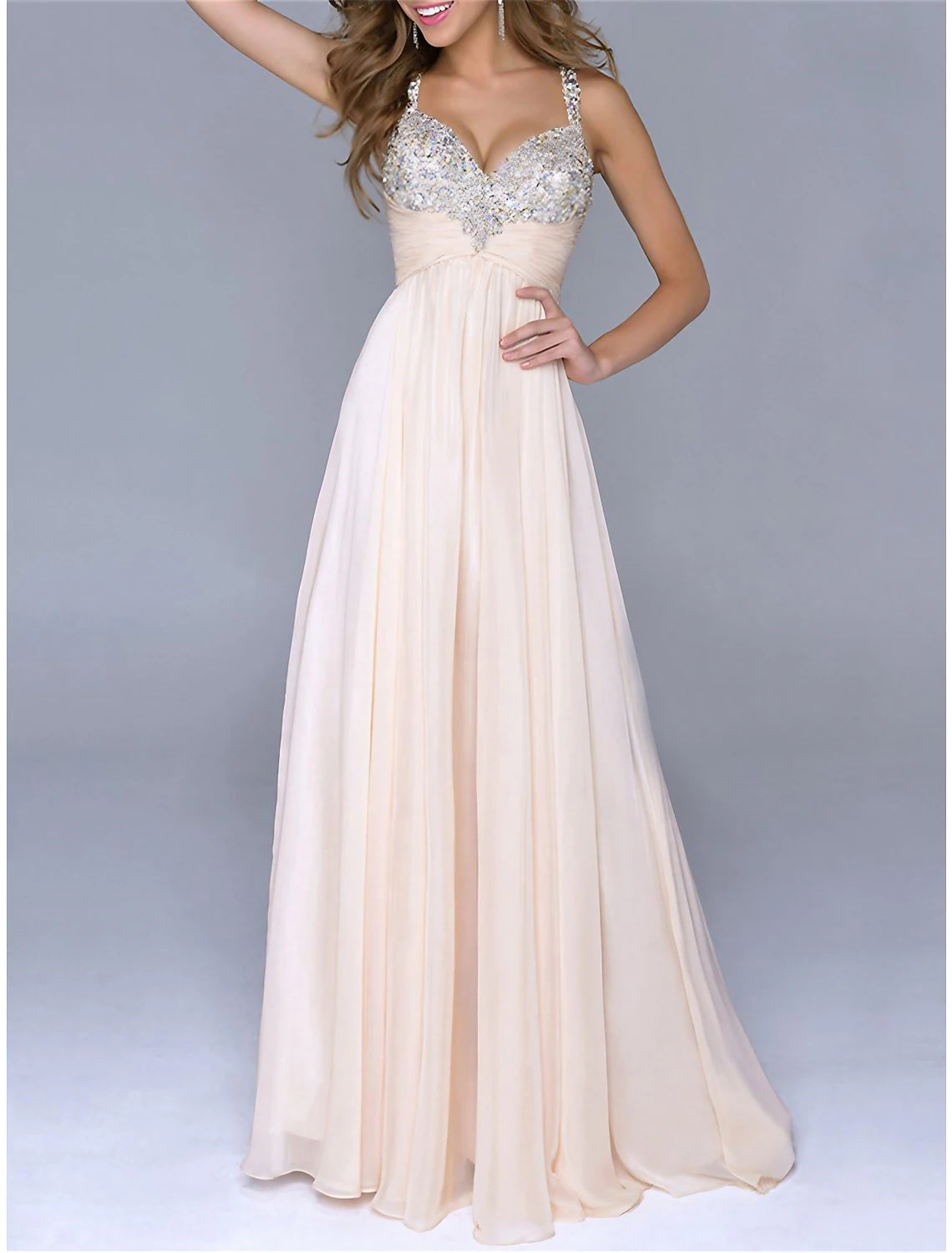 Woman wearing a sparkly sequin maxi dress with spaghetti straps, front view.