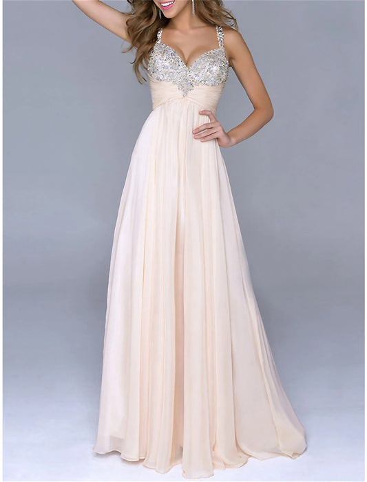 Woman wearing a sparkly sequin maxi dress with spaghetti straps, front view.