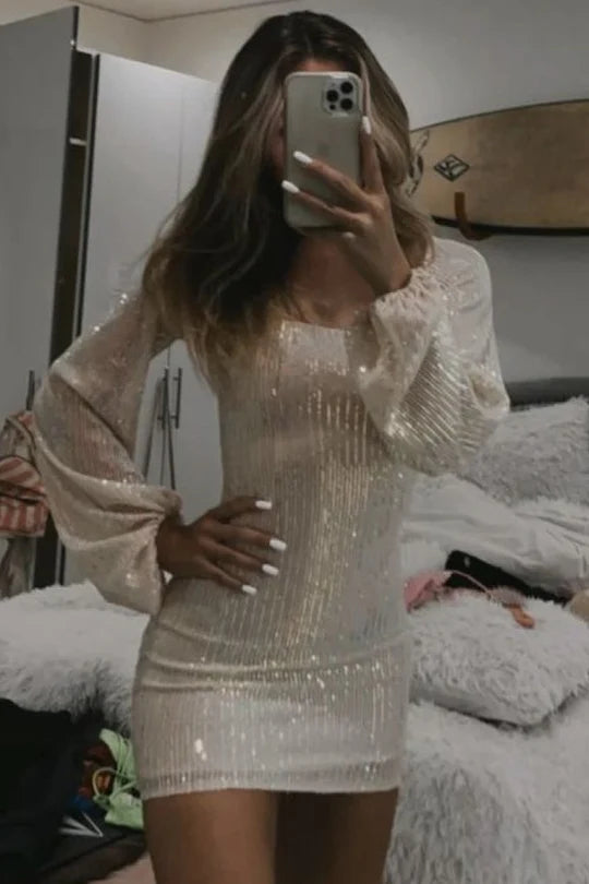 Model wearing a sparkly long sleeve scoop neck sequined tight homecoming dress.
