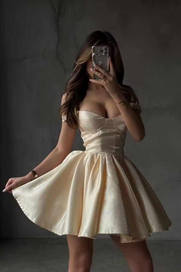 Model wearing a champagne A-line off-shoulder homecoming dress, front view.