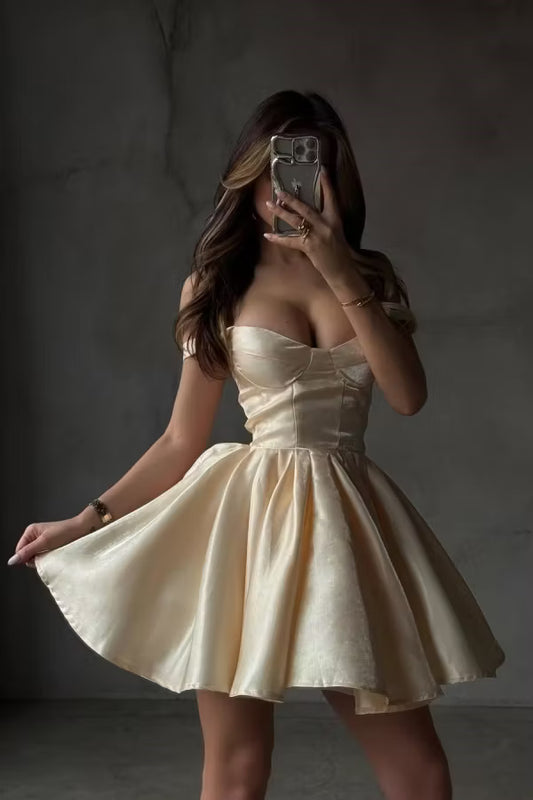Model wearing a champagne A-line off-shoulder homecoming dress, front view.