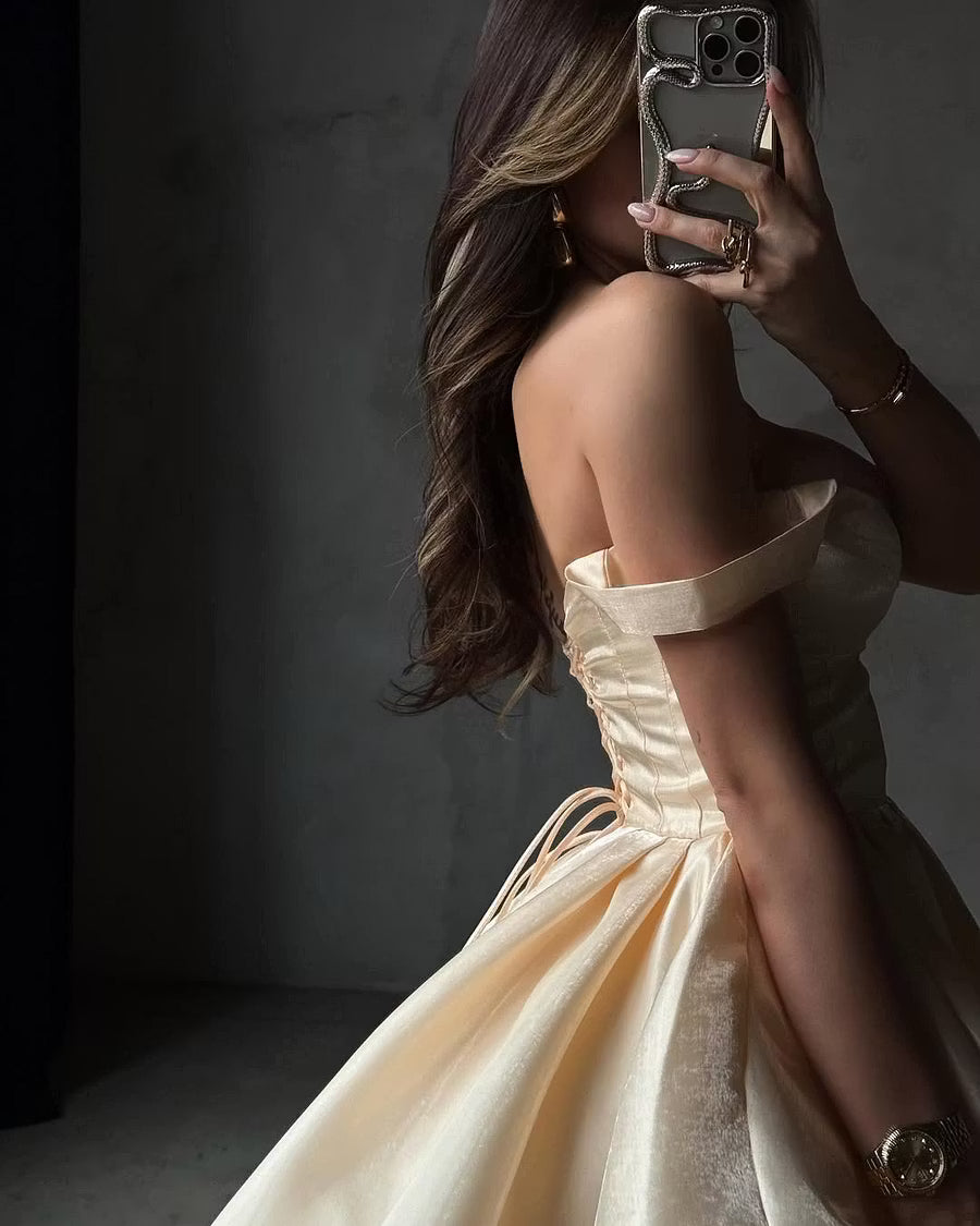 Close-up of the champagne satin off-shoulder sweetheart neckline and bodice details.