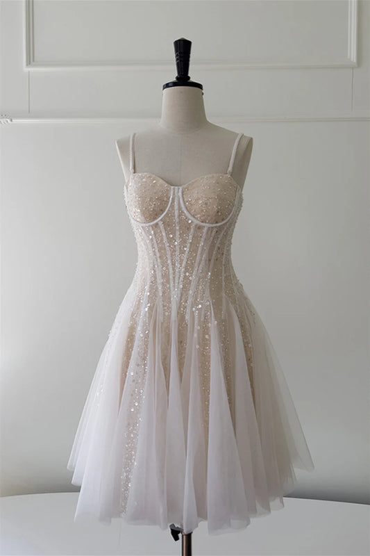 Model wearing a champagne sequin and beaded A-line short dress.