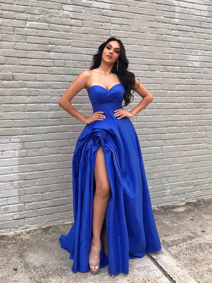 Royal blue satin A-line long evening dress with a high slit, worn by a model.