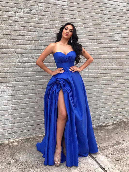 Royal blue satin A-line long evening dress with a high slit, worn by a model.