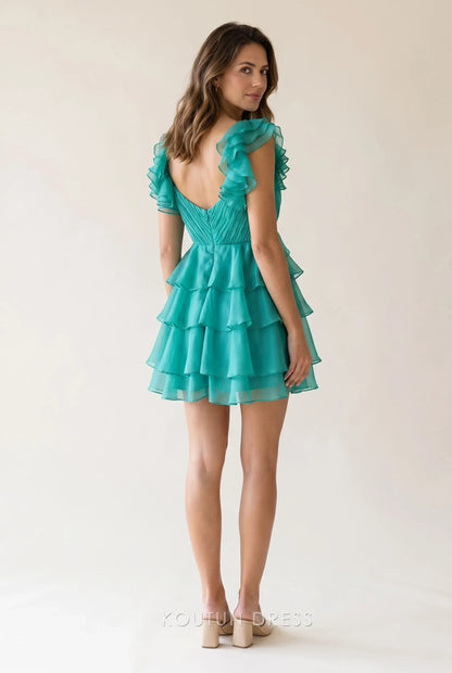Back view of the teal green chiffon mini dress, showcasing the low open back and multi-tier ruffle hem.