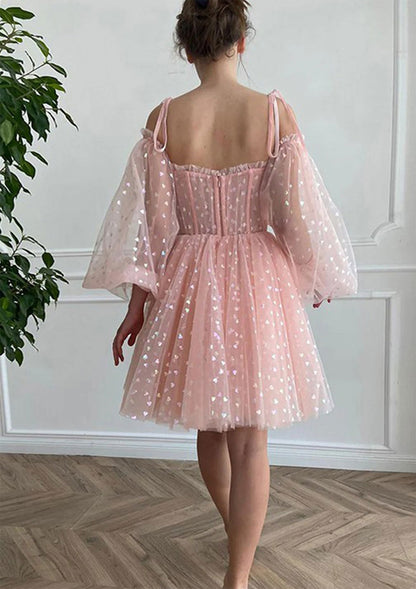 Back view of the blush pink off-shoulder puff sleeve A-line homecoming dress with corset detail.