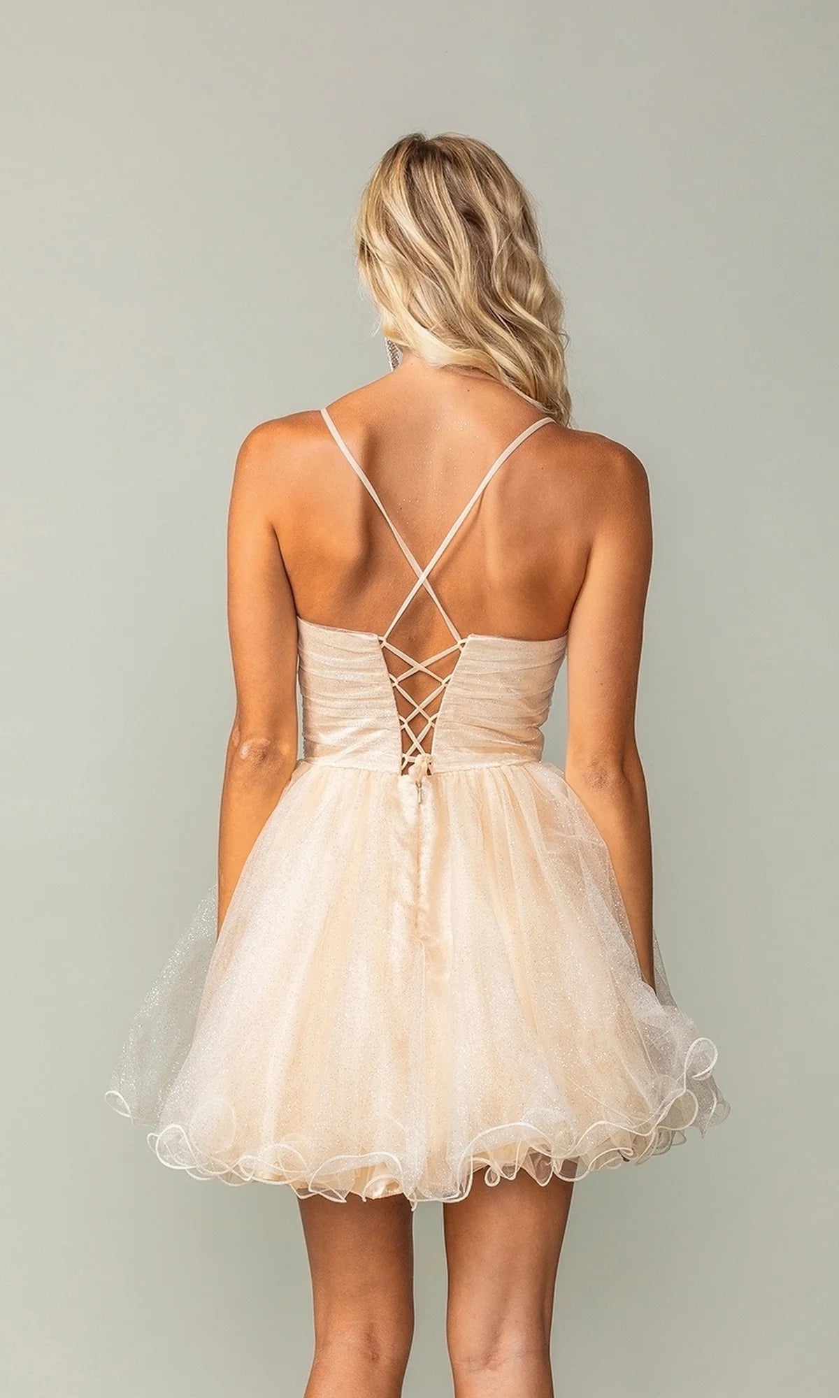 Back view of Koutun A-Line V-Neck short homecoming dress showing lace-up corset and ruffled hem.