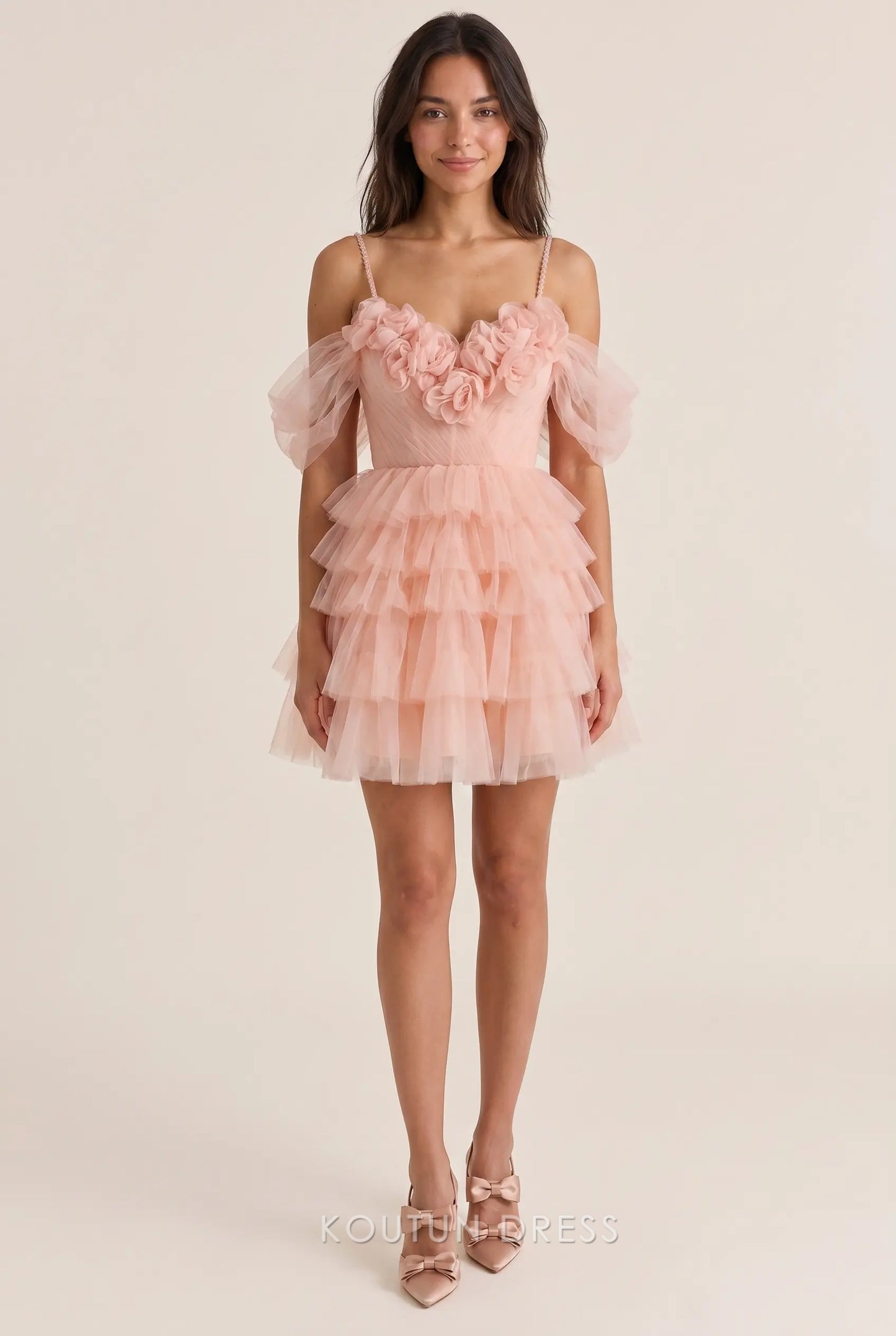 Model wearing a whimsical off-shoulder sweetheart tulle mini homecoming dress with 3D floral appliqués.
