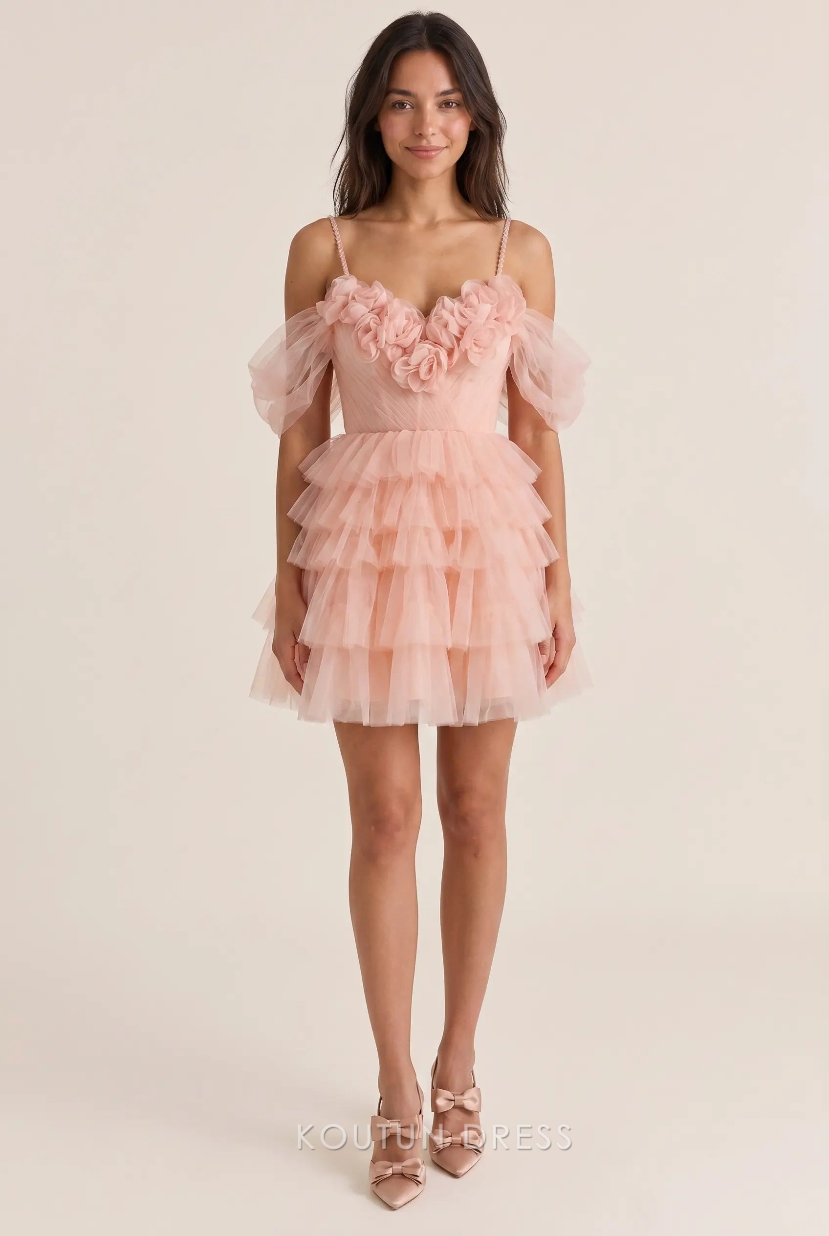 Model wearing a whimsical off-shoulder sweetheart tulle mini homecoming dress with 3D floral appliqués.