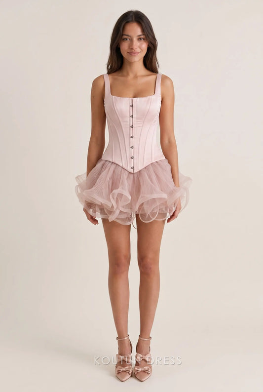 Model wearing a Koutun square neck satin corset mini homecoming dress with ruffled tulle skirt.