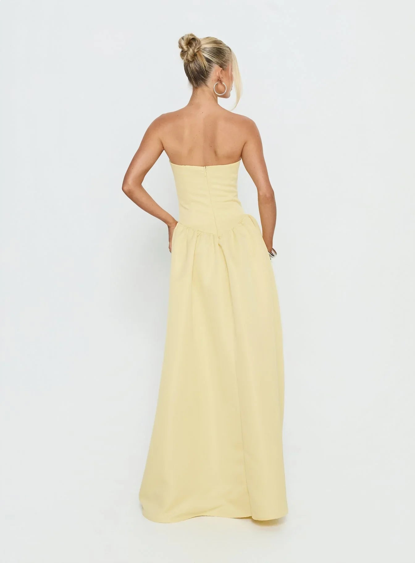 Yellow Strapless Prom Dress with Structured Corset Bodice and Voluminous Ball Gown Skirt for Formal Events and Prom Nights