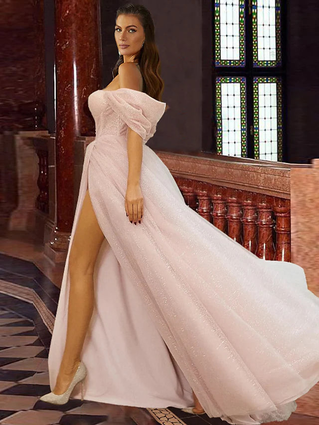 Side profile of the elegant off-shoulder prom dress with glitter details.