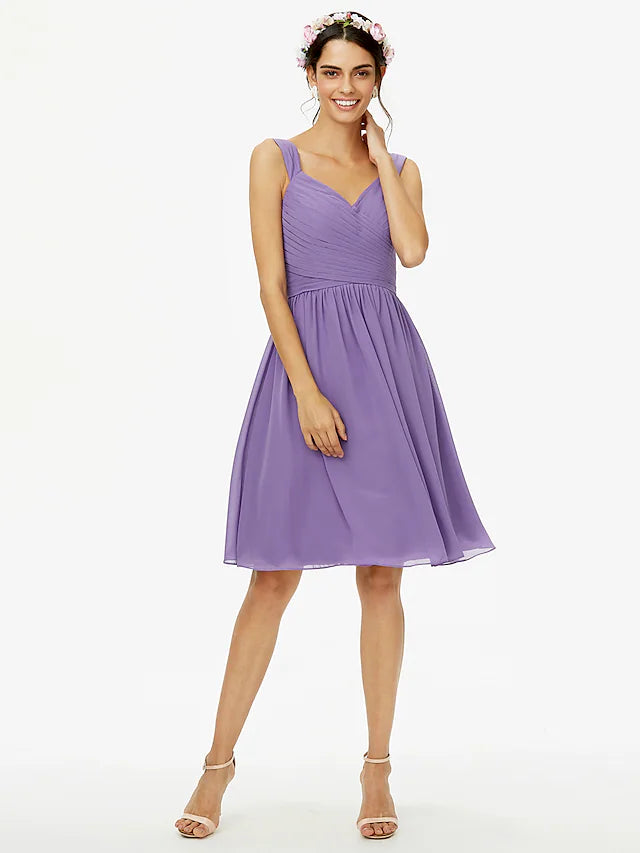 Close-up of the blush pink A-line bridesmaid dress details, including the delicate straps, sash, and chiffon texture.