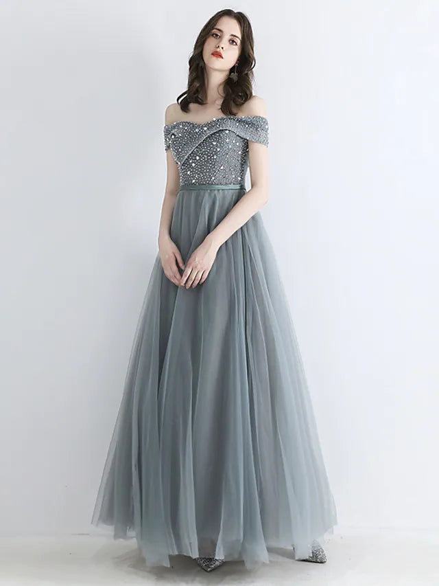 Model wearing A-Line mini homecoming dress with illusion neck and ruffles.