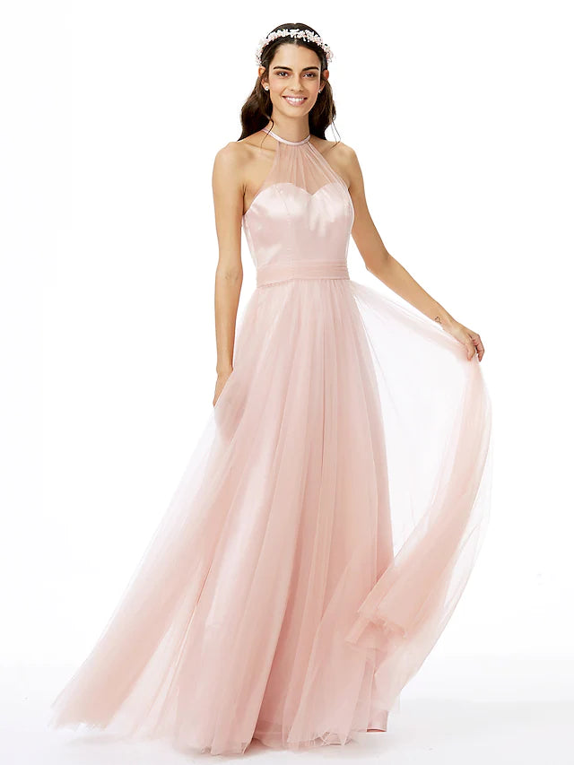 Model wearing an A-line jewel neck tulle bridesmaid dress with sheer details and pleats.