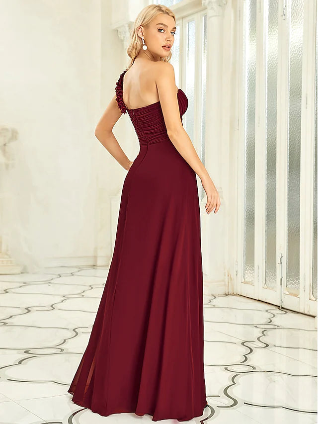 Close-up of the off-shoulder neckline and pleated bodice of the chiffon gown.