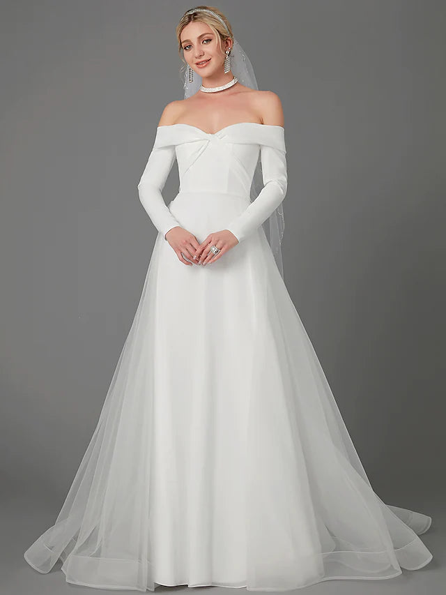 Full view of an A-Line off-shoulder long sleeve chiffon wedding dress with a criss-cross back.
