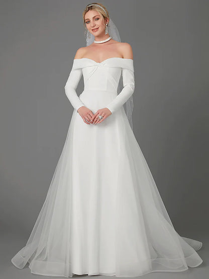 Full view of an A-Line off-shoulder long sleeve chiffon wedding dress with a criss-cross back.