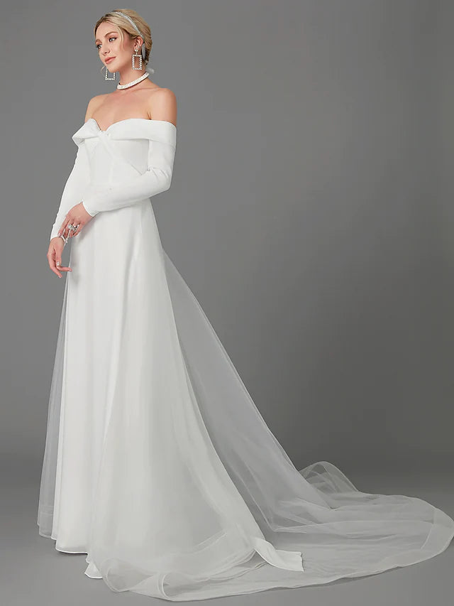Side view of an A-Line off-shoulder long sleeve chiffon wedding dress, showing the flowing skirt.