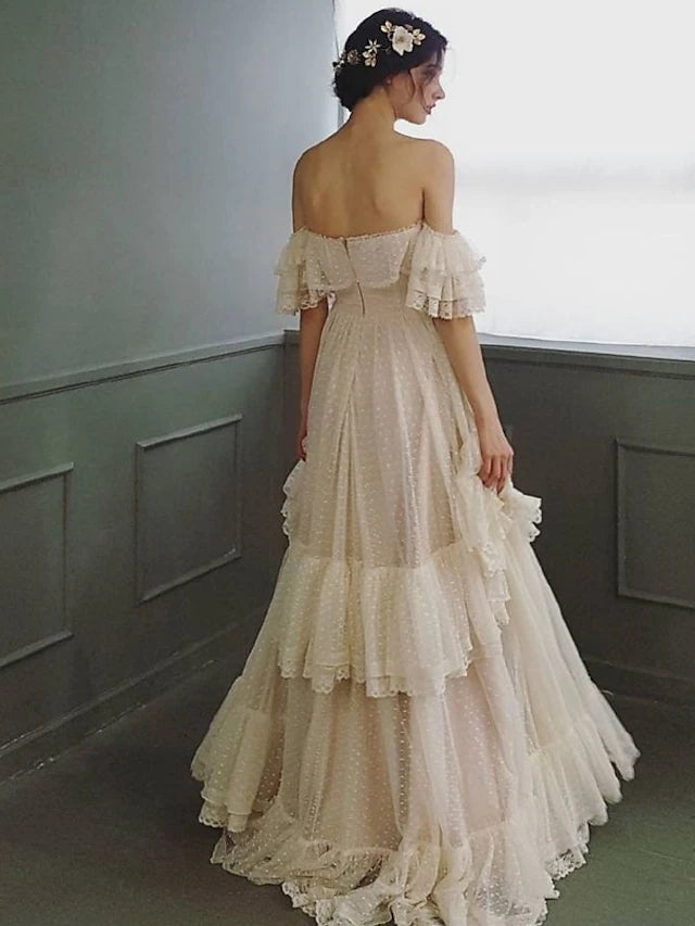 Back view of an A-Line off-shoulder lace wedding dress with sweep train.