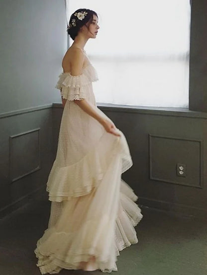 Side profile of a bride wearing an A-Line off-shoulder lace wedding dress.