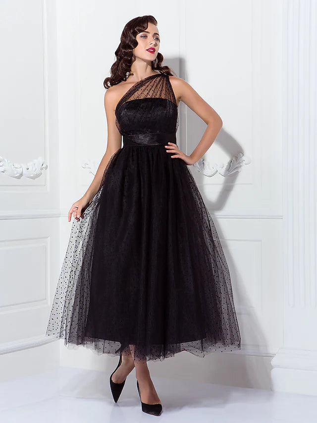 Model wearing an elegant black one-shoulder A-line tulle cocktail dress, front view.