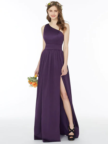 Model in an A-line one-shoulder chiffon bridesmaid dress with a sash and split front.