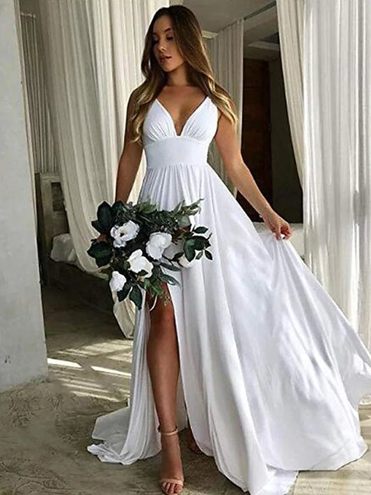 Woman in a light blue A-line plunging neck chiffon bridesmaid dress with pleats and a split front.