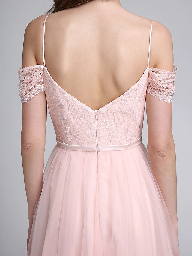 Side view of woman in floor-length lace tulle bridesmaid gown.