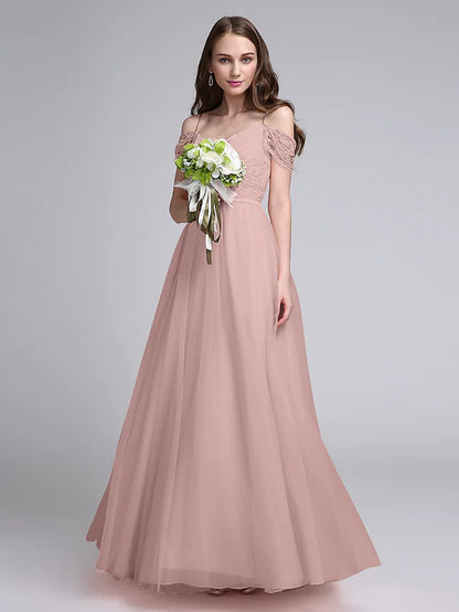 Woman posing in a spaghetti strap A-Line bridesmaid dress.