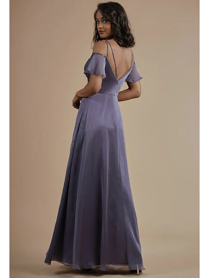 A woman in a light blue A-line chiffon bridesmaid dress, showing the open back and split front details.