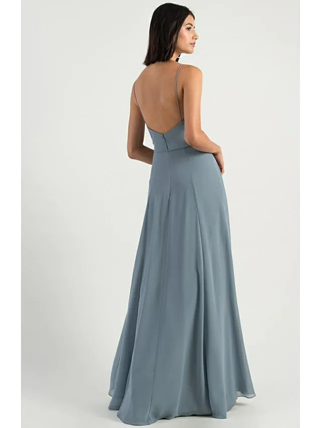 Model posing gracefully in a floor-length chiffon bridesmaid dress with a split front.
