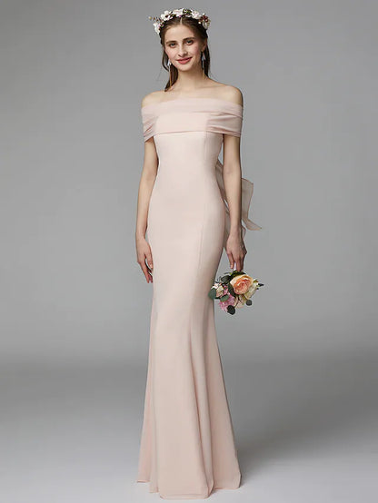 Front view of an elegant strapless backless chiffon bridesmaid dress with a sash and pleats.