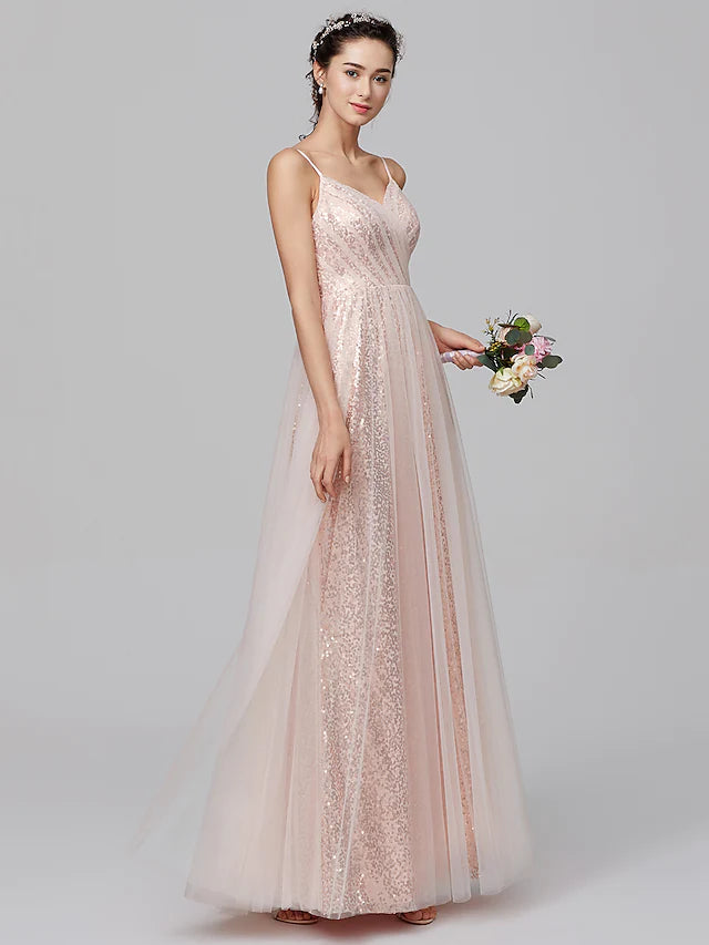 Model wearing an A-line spaghetti strap sequined tulle bridesmaid dress, side view.