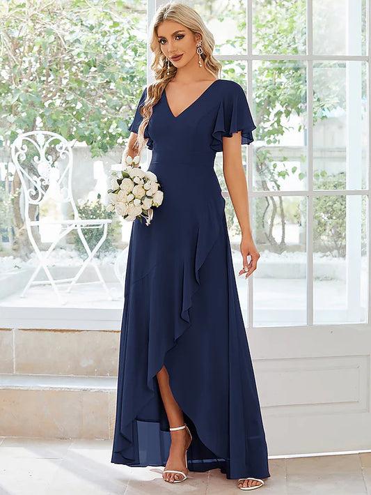 Side view of a woman in an A-line V-neck asymmetrical ruffled blue chiffon mini dress.