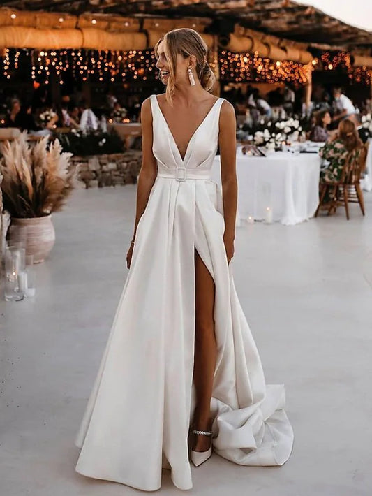 Full view of an elegant A-Line V-neck open back satin wedding dress with a court train.
