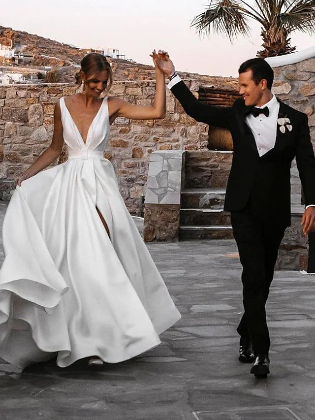 Back view of the satin wedding dress, highlighting the open back design and delicate sashes.