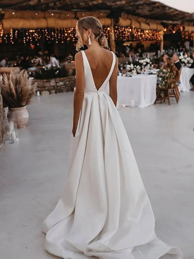 Close-up of the V-neckline and luxurious satin fabric of the bridal gown.