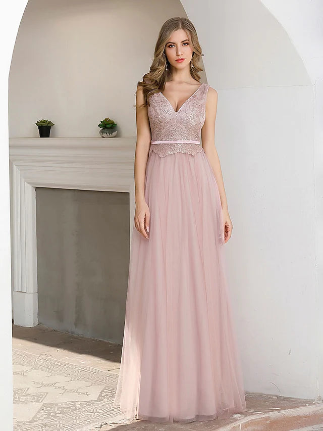 Model wearing an A-line V-neck satin evening gown, showing the V-back and sequin sash detail.