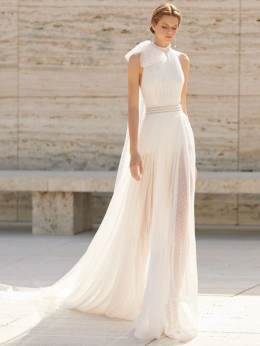 Model wearing a high-neck, sleeveless boho sheath wedding dress with a court train and delicate pattern.