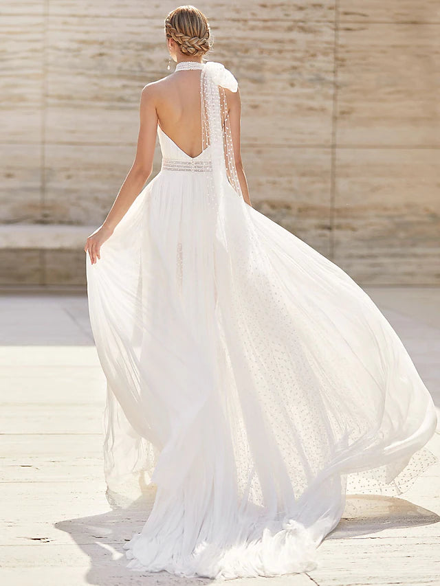 Back view of a high-neck boho wedding dress, showcasing the court train, chiffon fabric, and pattern.
