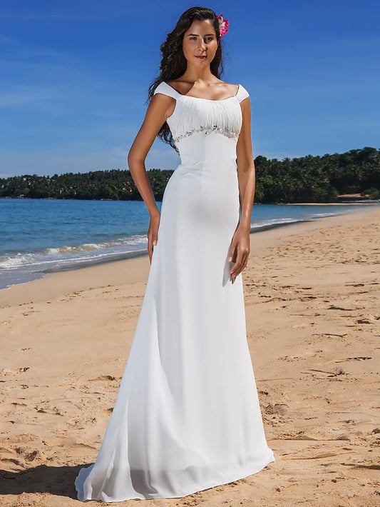 Model wearing a casual chiffon wedding dress with cap sleeves and scoop neck.