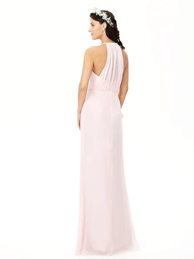 Side profile of a woman showcasing the flowing chiffon and pleats of the bridesmaid dress.