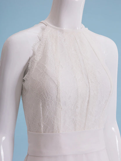 Side profile of a bride in a white halter neck wedding dress.