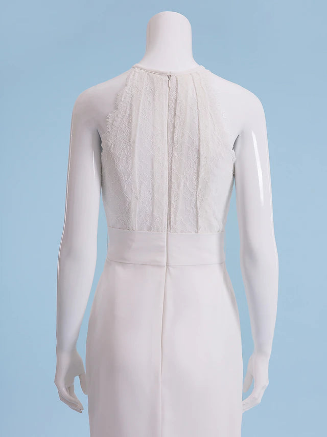 Close-up of the intricate lace detail on a halter neck wedding dress.