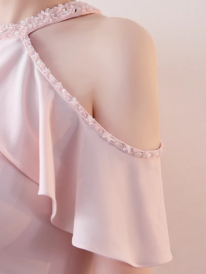 Close-up of the beaded halter neckline and short sleeves.