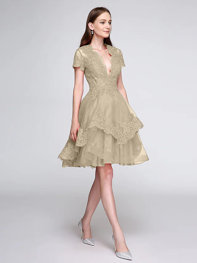 Close-up of the plunging V-neckline and short sleeve detail.