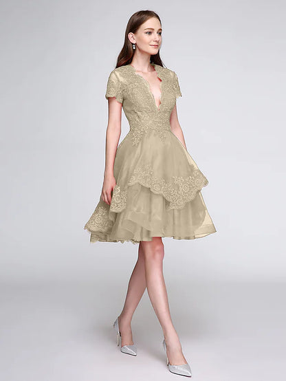Close-up of the plunging V-neckline and short sleeve detail.